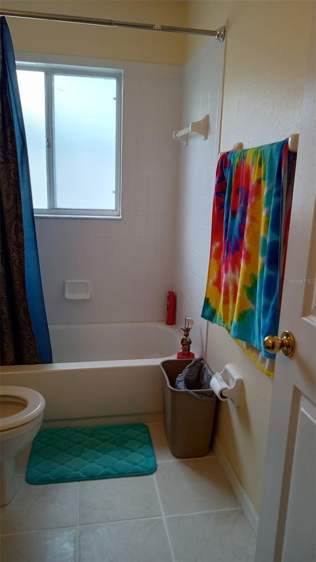 full bathroom with tile patterned floors, toilet, and shower / bathtub combination with curtain