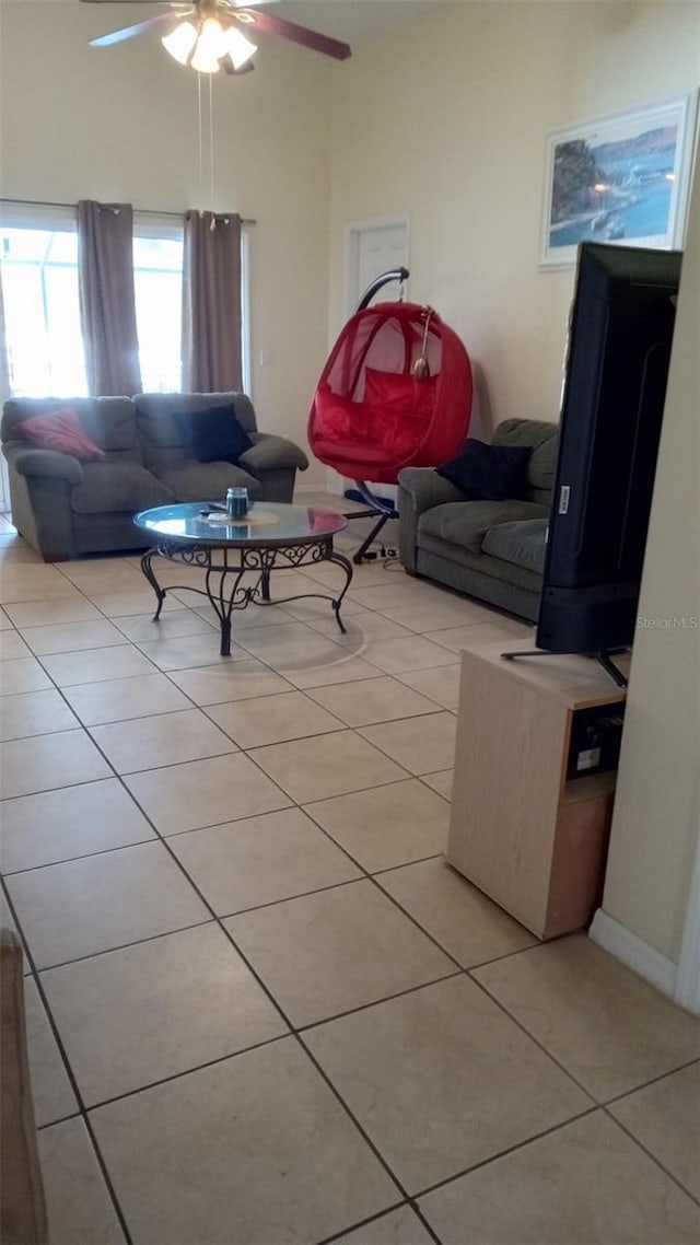 living room with light tile patterned floors and ceiling fan