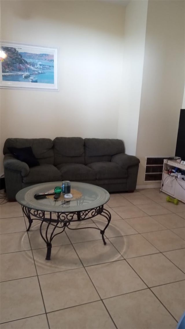 living area featuring light tile patterned flooring and visible vents