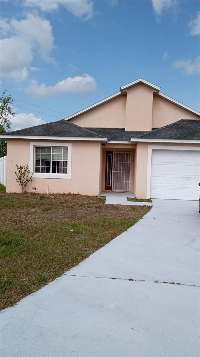 ranch-style house with driveway, roof with shingles, a front yard, stucco siding, and a garage