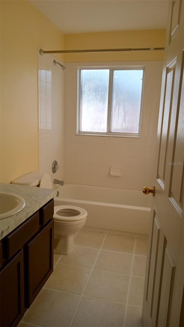 bathroom with toilet, vanity, shower / tub combination, and tile patterned floors
