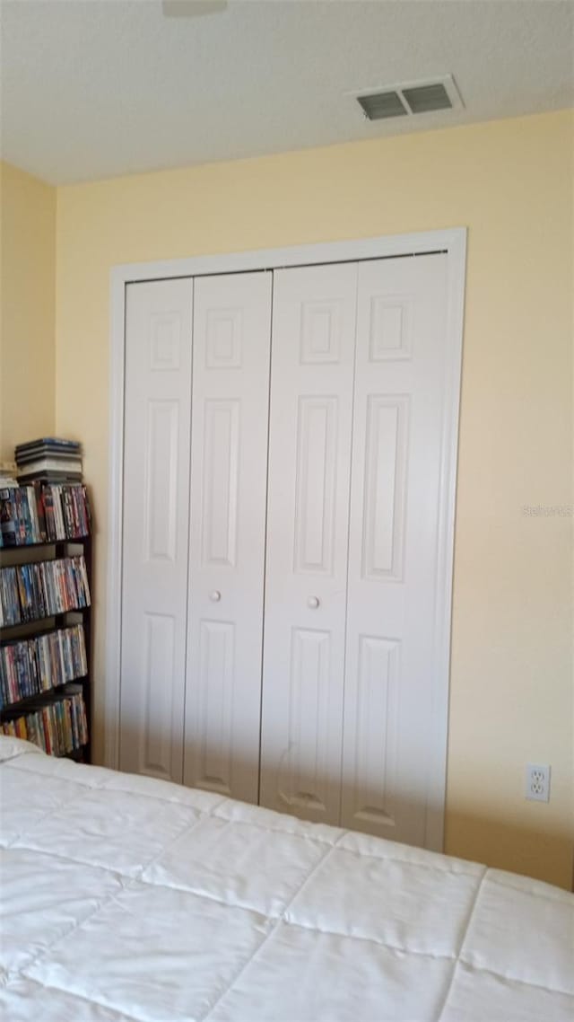 bedroom with a closet and visible vents