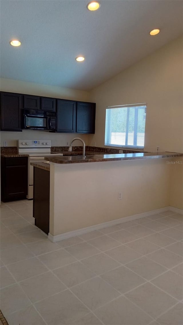 kitchen featuring black microwave, dark countertops, light tile patterned flooring, electric stove, and recessed lighting