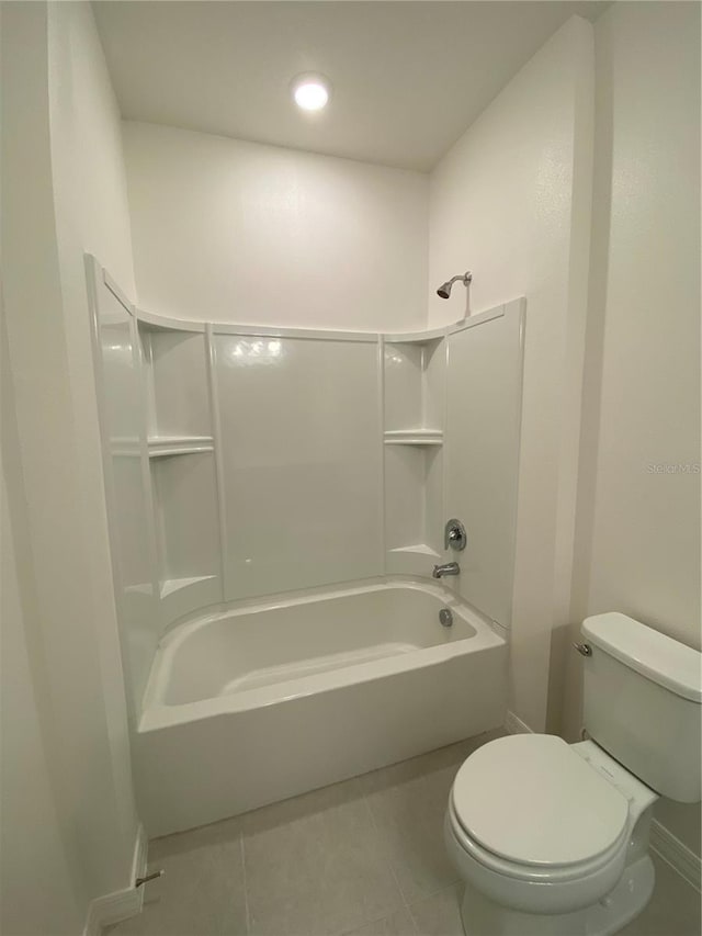 bathroom featuring bathtub / shower combination, tile patterned floors, toilet, and baseboards