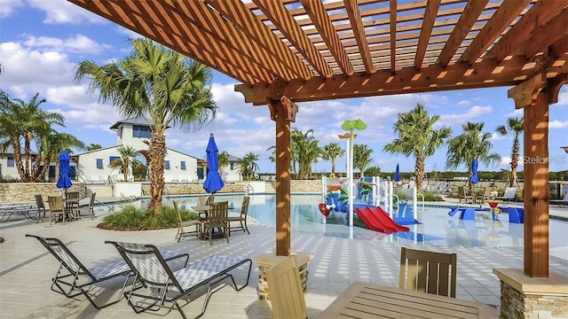 view of patio / terrace with a community pool, outdoor dining space, and a pergola