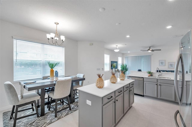 5728 Skytop Dr, Lithia, FL 33547 - kitchen featuring stainless steel appliances, gray cabinetry, a sink, a kitchen island, and a chandelier
