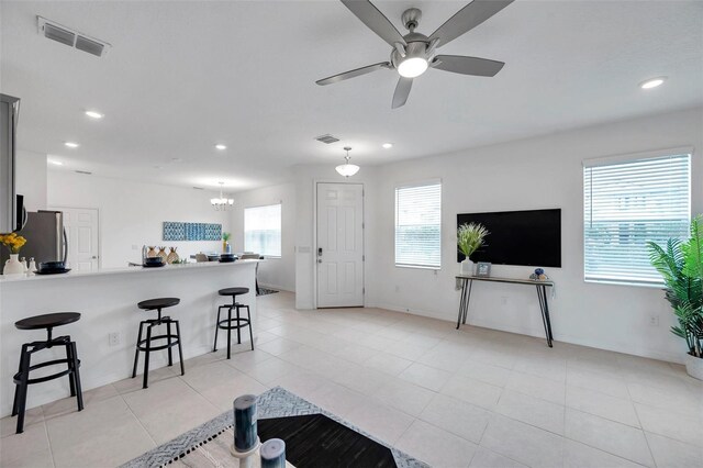 5728 Skytop Dr, Lithia, FL 33547 - living room featuring ceiling fan, recessed lighting, baseboards, light tile patterned floors, and a chandelier