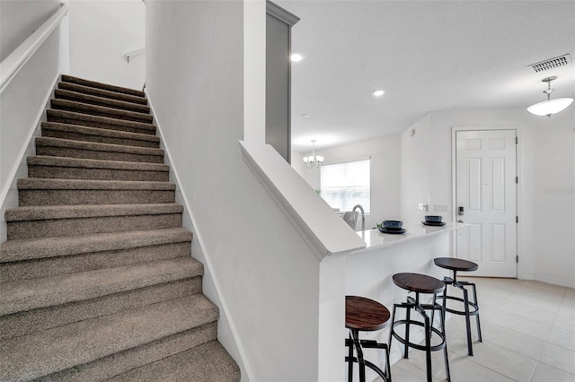 5728 Skytop Dr, Lithia, FL 33547 - staircase with baseboards, tile patterned floors, recessed lighting, and a chandelier