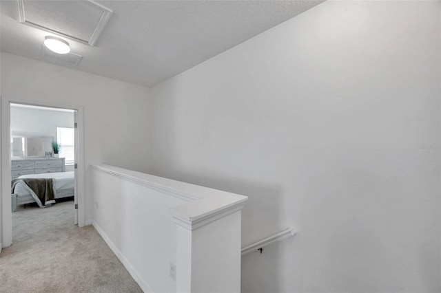 5728 Skytop Dr, Lithia, FL 33547 - hallway with an upstairs landing, light carpet, attic access, and baseboards