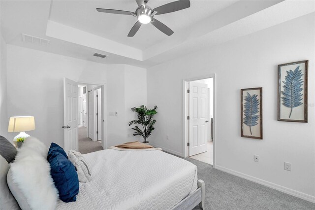 5728 Skytop Dr, Lithia, FL 33547 - bedroom featuring light colored carpet, a raised ceiling, baseboards, and a ceiling fan