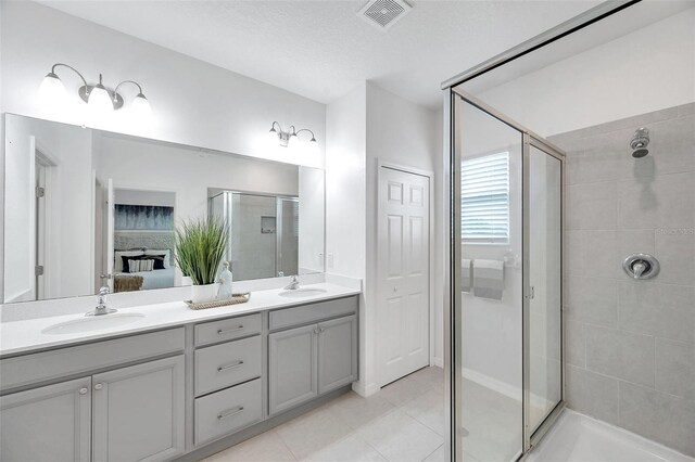 5728 Skytop Dr, Lithia, FL 33547 - full bath with connected bathroom, a stall shower, tile patterned floors, and double vanity