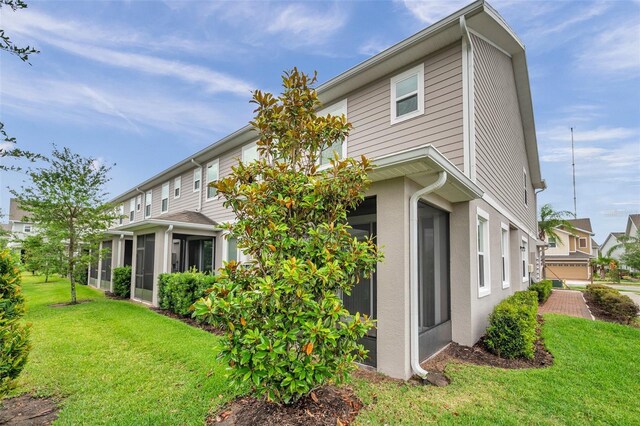 5728 Skytop Dr, Lithia, FL 33547 - back of house with a yard, a sunroom, and stucco siding