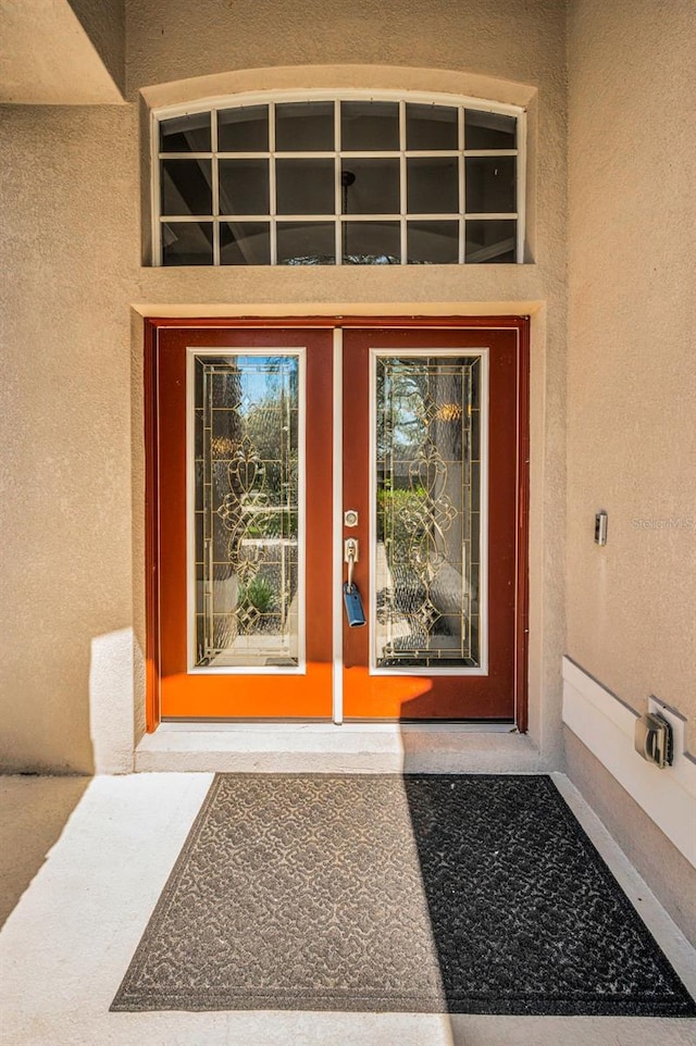 entrance to property with stucco siding