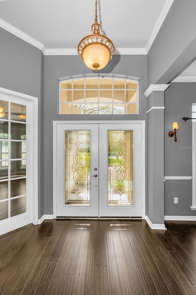 entryway featuring wood finished floors, crown molding, and french doors