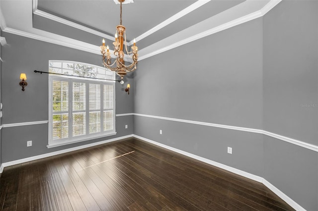 unfurnished room featuring a chandelier, baseboards, a tray ceiling, and hardwood / wood-style flooring