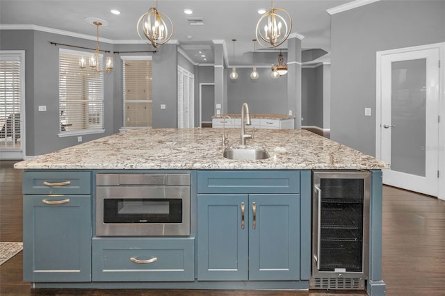 kitchen featuring wine cooler, crown molding, an inviting chandelier, and a sink