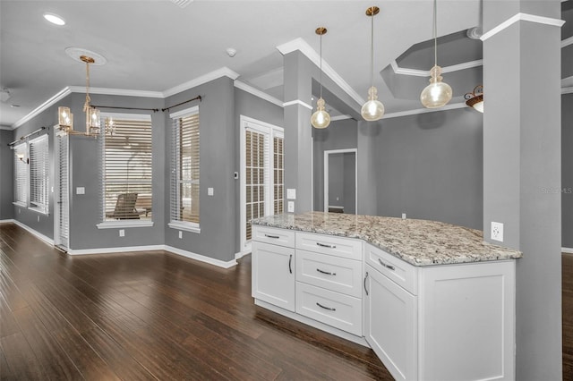 kitchen featuring light stone counters, dark wood-style floors, white cabinets, crown molding, and a chandelier