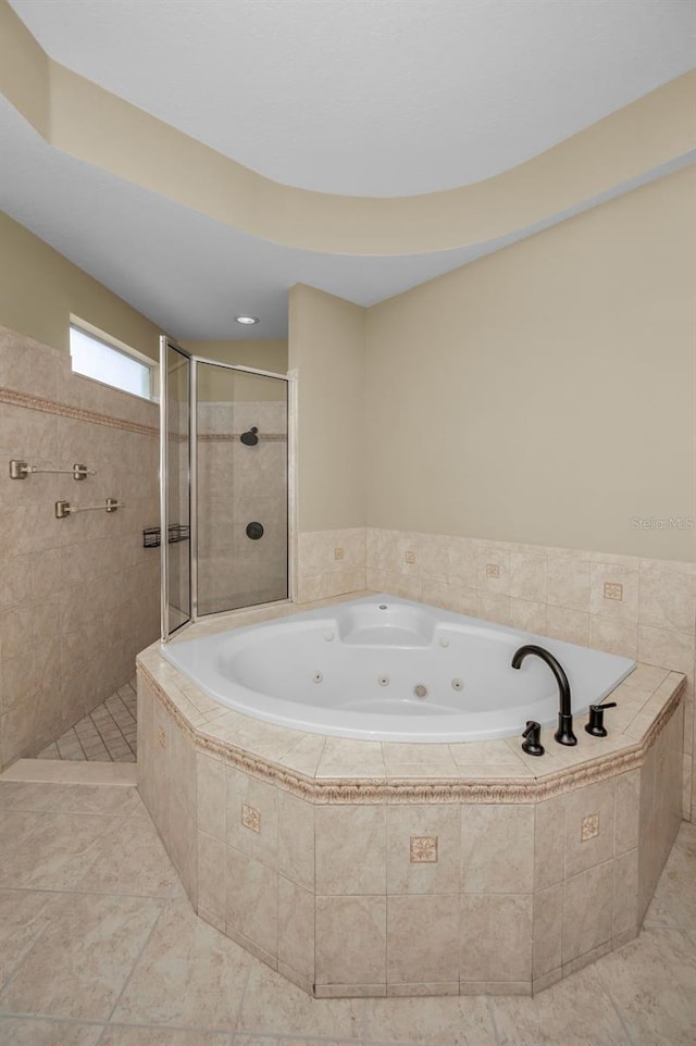 full bathroom with a tub with jets and a tile shower