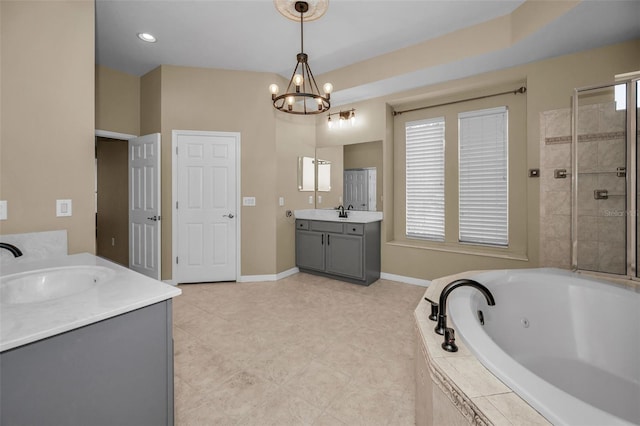 full bath with two vanities, a sink, baseboards, a chandelier, and a whirlpool tub