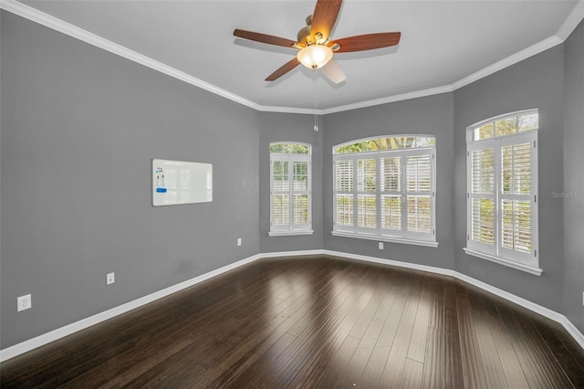 unfurnished room with dark wood-style floors, crown molding, and baseboards