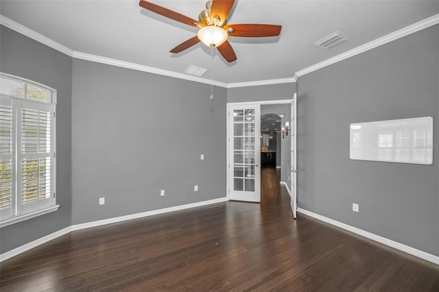 spare room with wood finished floors, baseboards, visible vents, arched walkways, and ceiling fan