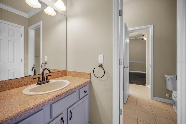 bathroom featuring toilet, crown molding, tile patterned flooring, ceiling fan, and vanity