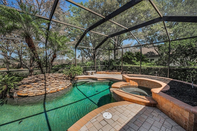 view of swimming pool with a patio area, a lanai, and a pool with connected hot tub