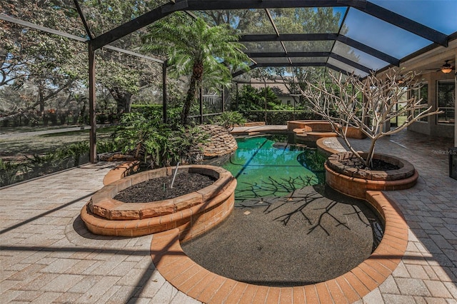 view of patio with glass enclosure and a pool with connected hot tub