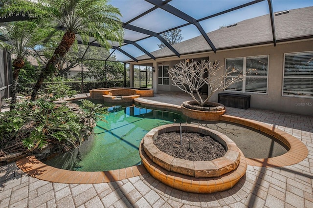 view of patio with glass enclosure and a pool with connected hot tub