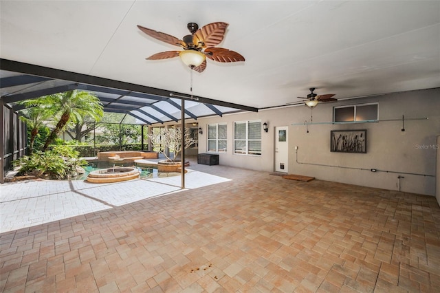 view of patio with a lanai and a ceiling fan