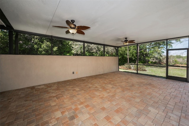 unfurnished sunroom featuring a ceiling fan