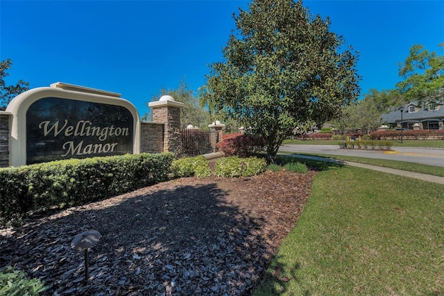 community sign featuring a lawn