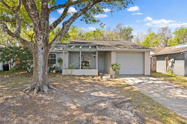 view of front of home with a shingled roof, a garage, driveway, and stucco siding