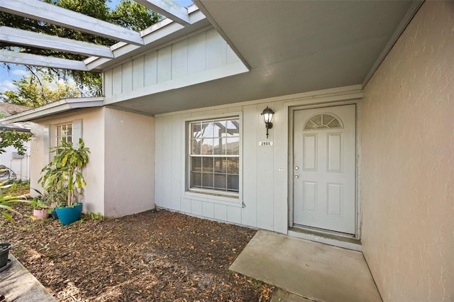 doorway to property featuring board and batten siding