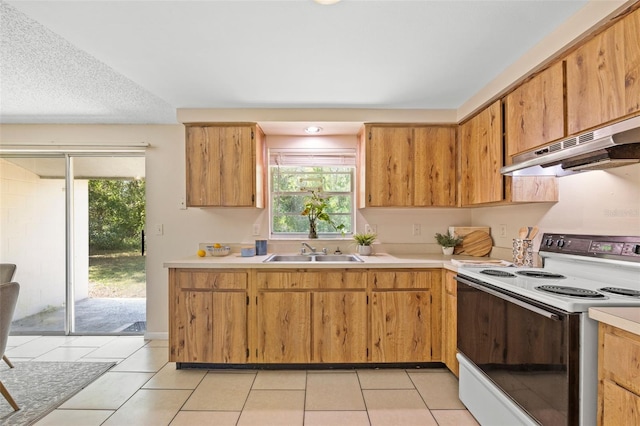 kitchen featuring light tile patterned floors, electric range, a sink, light countertops, and under cabinet range hood