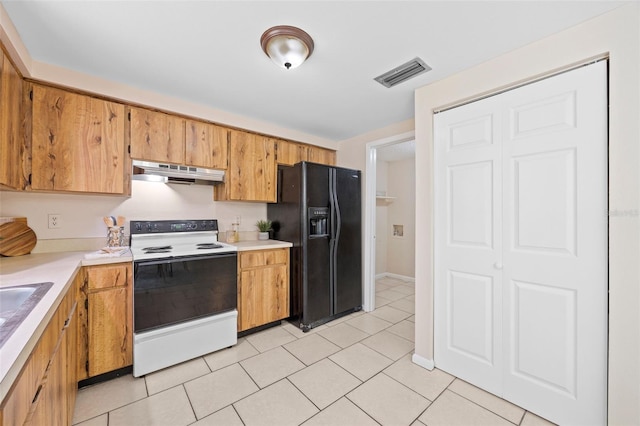 kitchen with electric range, visible vents, under cabinet range hood, black fridge with ice dispenser, and light countertops