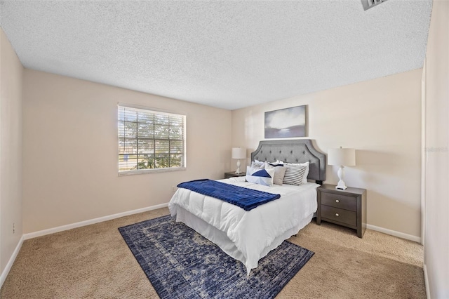 carpeted bedroom with baseboards and a textured ceiling