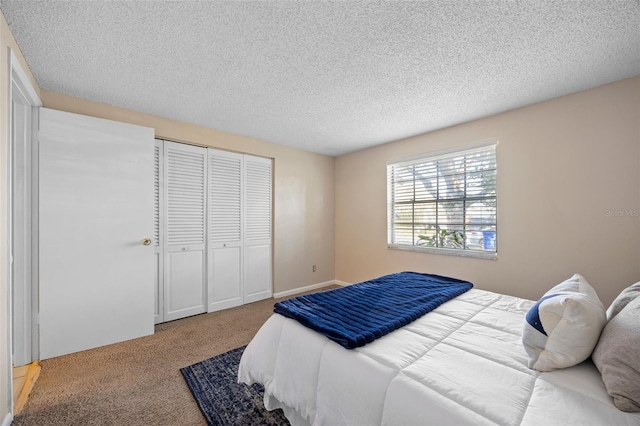 carpeted bedroom featuring a closet and a textured ceiling