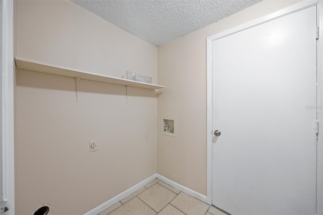 washroom with washer hookup, laundry area, light tile patterned flooring, electric dryer hookup, and a textured ceiling