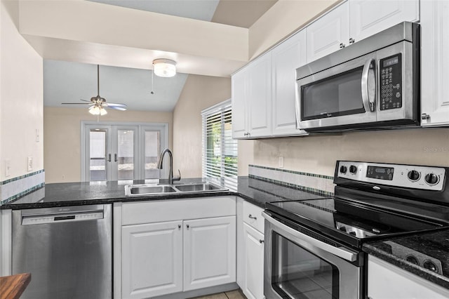 kitchen with a sink, white cabinetry, stainless steel appliances, french doors, and a peninsula