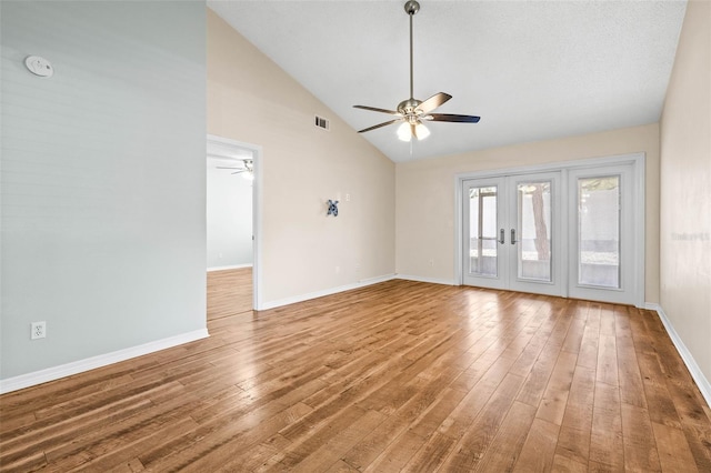 empty room featuring baseboards, visible vents, ceiling fan, hardwood / wood-style flooring, and french doors