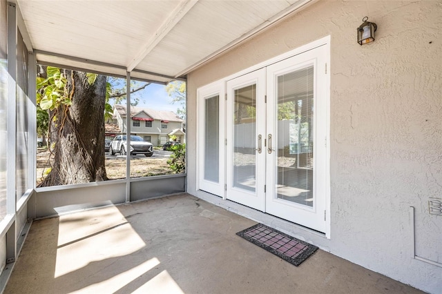 unfurnished sunroom featuring french doors