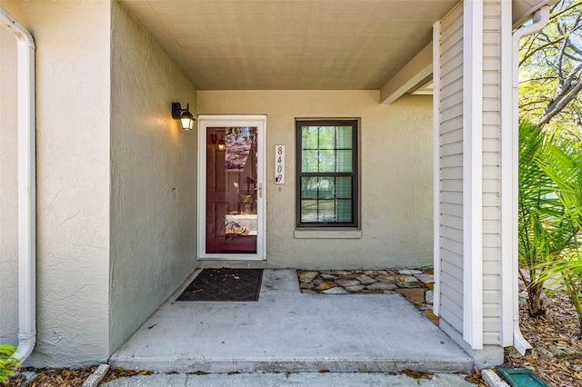 doorway to property with stucco siding