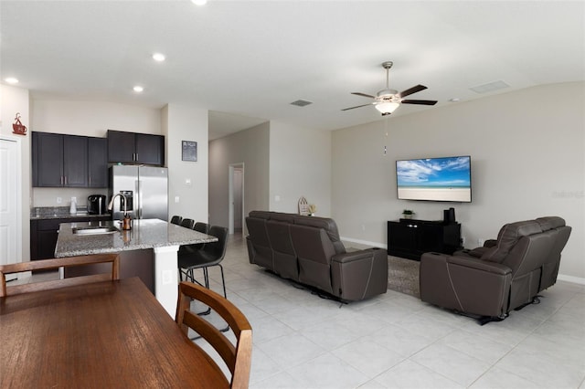 living room featuring visible vents, a ceiling fan, recessed lighting, light tile patterned floors, and vaulted ceiling