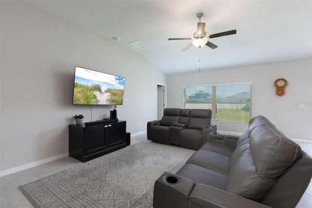 tiled living area featuring baseboards, lofted ceiling, visible vents, and a ceiling fan