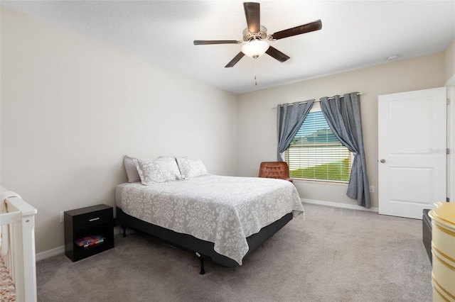 carpeted bedroom with baseboards and a ceiling fan