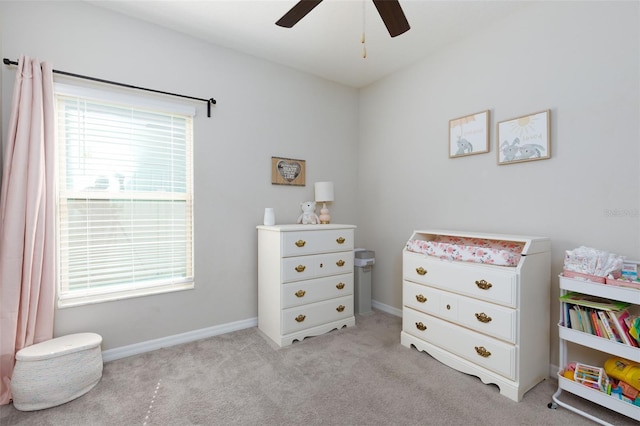 bedroom with a ceiling fan, baseboards, and light carpet