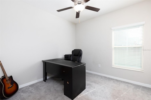 office space featuring light colored carpet, baseboards, and ceiling fan