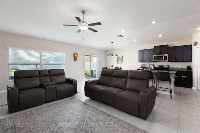 living room with visible vents, recessed lighting, light tile patterned flooring, baseboards, and ceiling fan