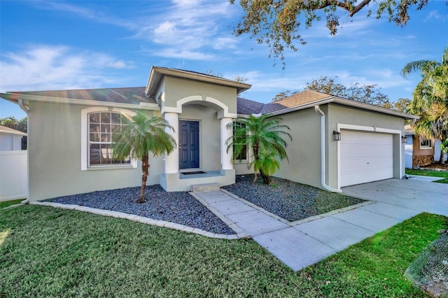 ranch-style house with a front yard, driveway, a shingled roof, stucco siding, and a garage